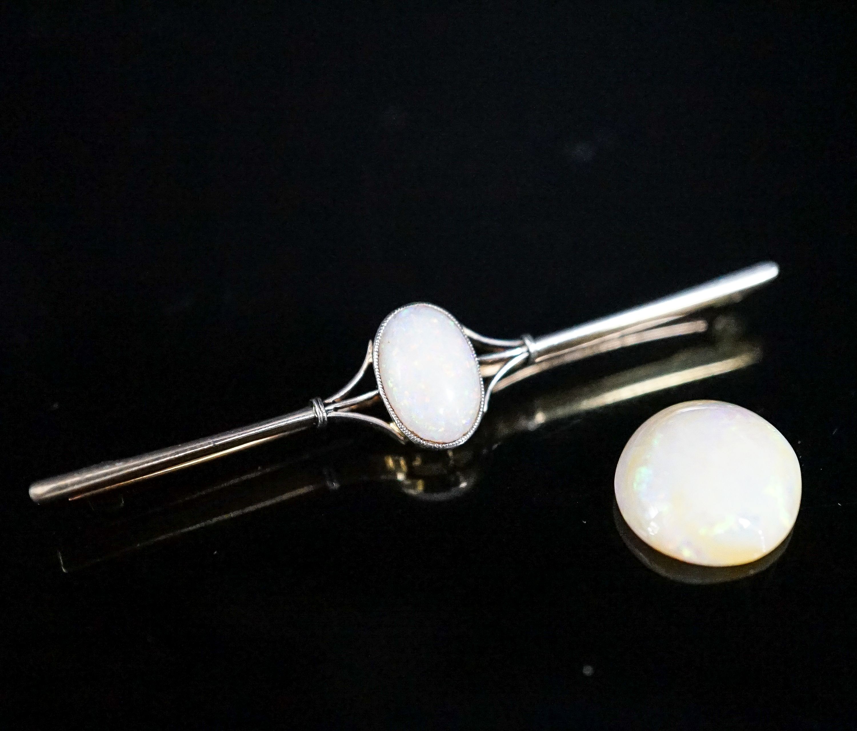 A yellow metal and white opal set bar brooch, 63mm, gross 4.9 grams and a loose white opal.